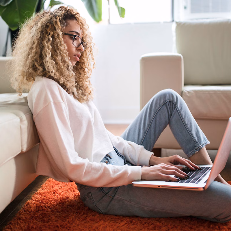 Woman Sitting on Floor Working Woman Sitting on Floor Working